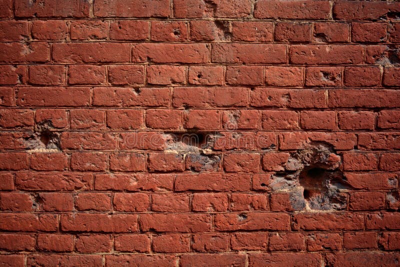 Vieux mur de briques de fond avec des trous des balles images stock Vieux mur de briques de fond avec des trous des balles images stock