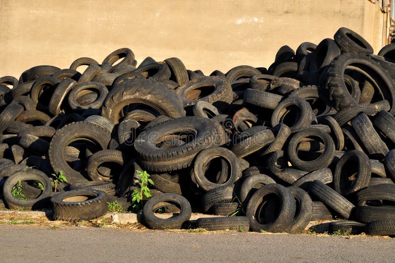 Old used rubber tires stack in storage. Old used rubber tires stack in storage.