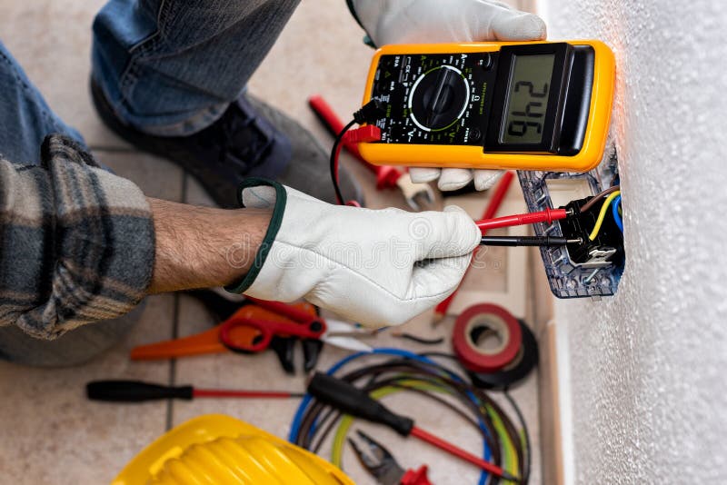 Electrician at Work on a Residential Electrical System. Electricity