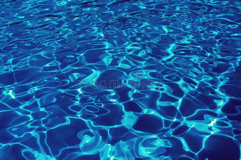 Swimming pool surface with ripples and sunlight reflection, vintage style. royalty free stock photo
