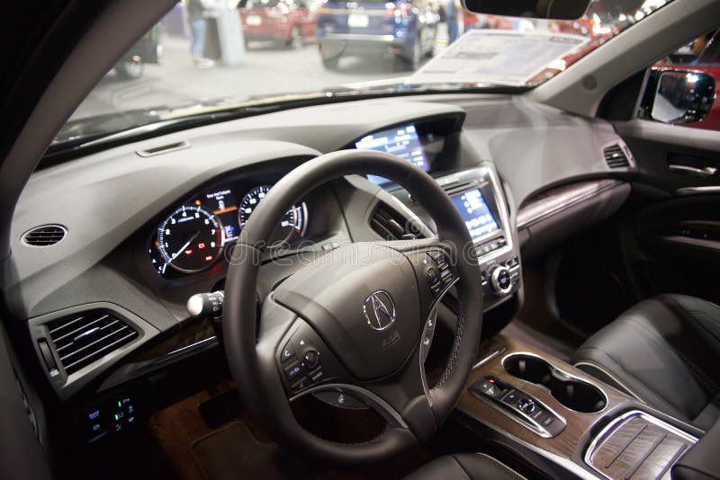 The Interior of the Car Acura MDX with a View of the Armrest and Seats