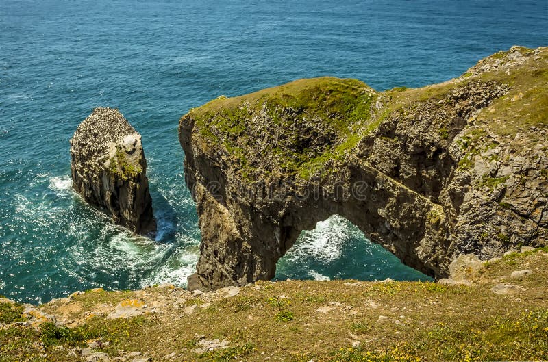 A view along the top of the Green Bridge of Wales on the Pembrokeshire coast royalty free stock photo A view along the top of the Green Bridge of Wales on the Pembrokeshire coast royalty free stock photo