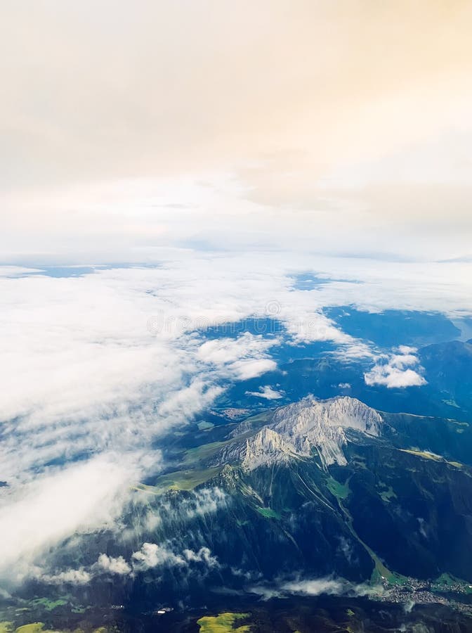 View of Alpine mountains from height, through airplane window. Airplane height stock images, royalty-free photos and pictures