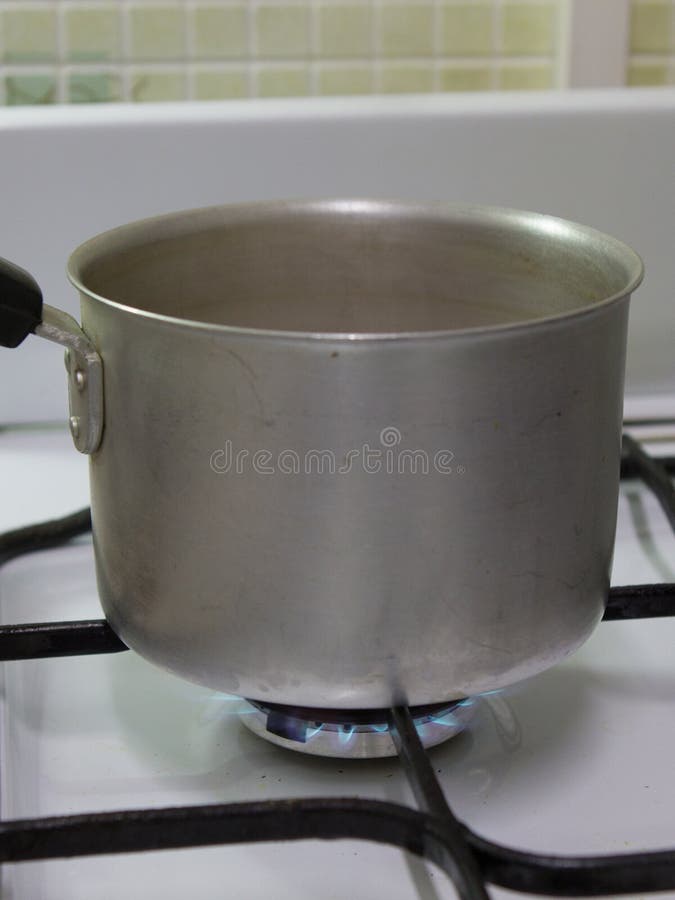 View of the Aluminum Bucket Standing on the Gas Stove Stock Image