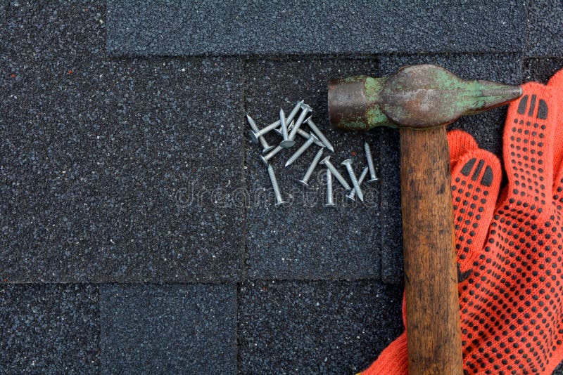 View on Asphalt Roofing Shingles Background. Roof Shingles - Roofing. Asphalt Roofing Shingles Hammer, Gloves and Nails stock photography View on Asphalt Roofing Shingles Background. Roof Shingles - Roofing. Asphalt Roofing Shingles Hammer, Gloves and Nails stock photography