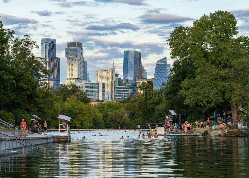 View of the Austin skyline at sunset over Barton Springs swimming pool royalty free stock photography