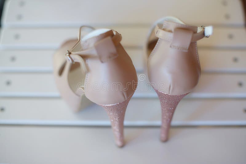 View from the back of an elegant high heel peep toe pumps shoes, with stiletto heel and ankle strap fastening stock photo View from the back of an elegant high heel peep toe pumps shoes, with stiletto heel and ankle strap fastening stock photo