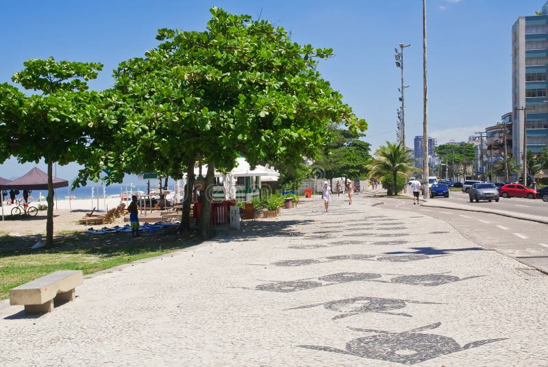 View of Barra da Tijuca beach with palms and mosaic of sidewalk stock image View of Barra da Tijuca beach with palms and mosaic of sidewalk stock image