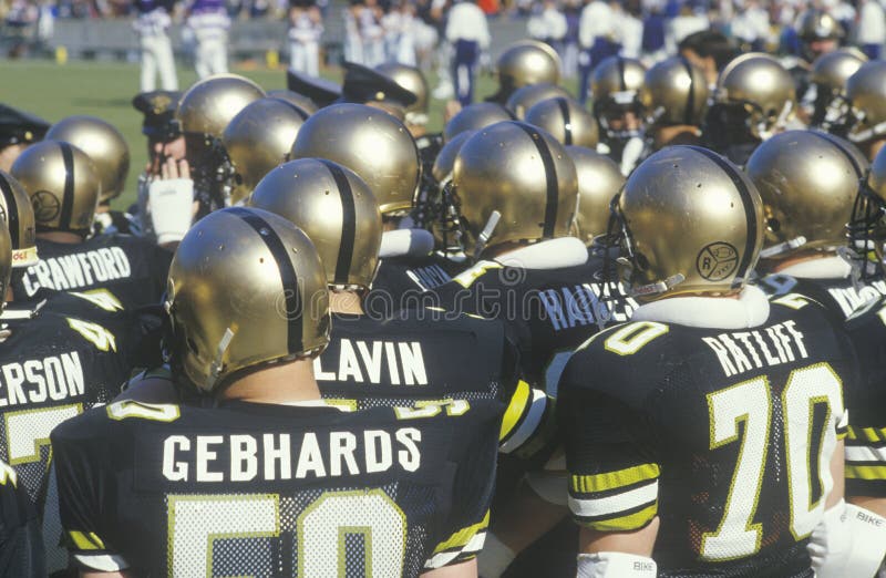 View from Behind of Group of College Football Players Watching