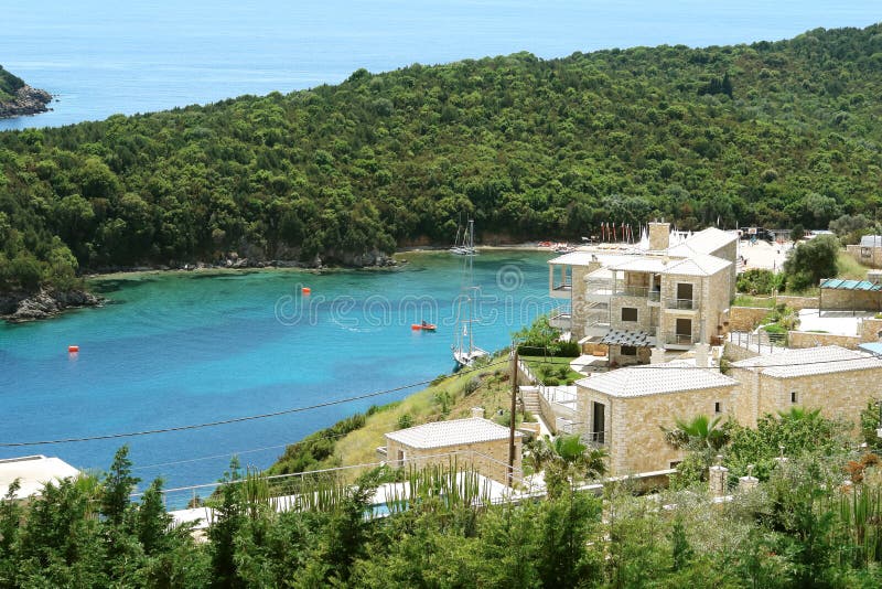 View of blue bay with green hills and yachts in the Ionian Sea i