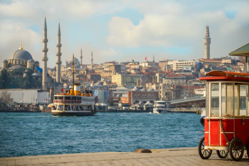 View of the Bosphorus and the old town on a sunny day. An old traditional merchant cart at the wharf. Istanbul. Turkey