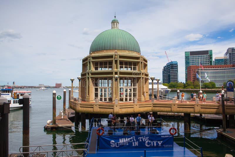 View of Boston from harbor and rowes wharf at sunset