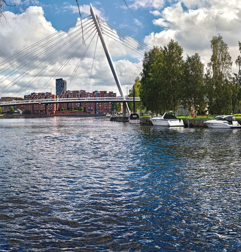 View of the bridge over the river Tammerkoski (Finland, Tampere, spring 2015), with boats, stock photo View of the bridge over the river Tammerkoski (Finland, Tampere, spring 2015), with boats, stock photo