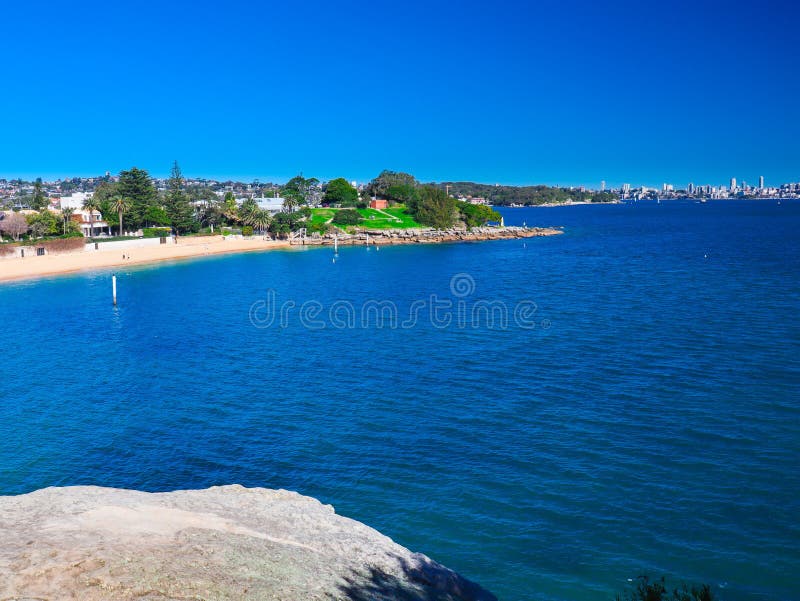 view of Camp Cove beach on Sydney Harbour NSW Australia blue skies clear turquoise waters of the bay white sandy bea