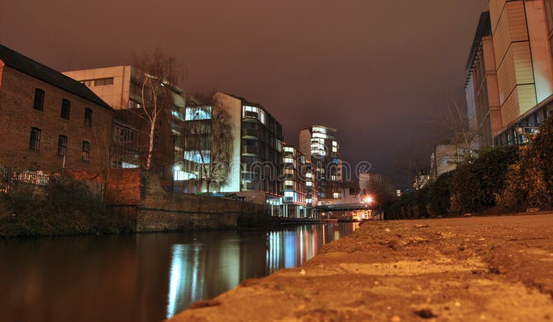 View on the canal and city landscape or cityscape at night, water reflection of shining lights, Trent street, Nottingham, UK