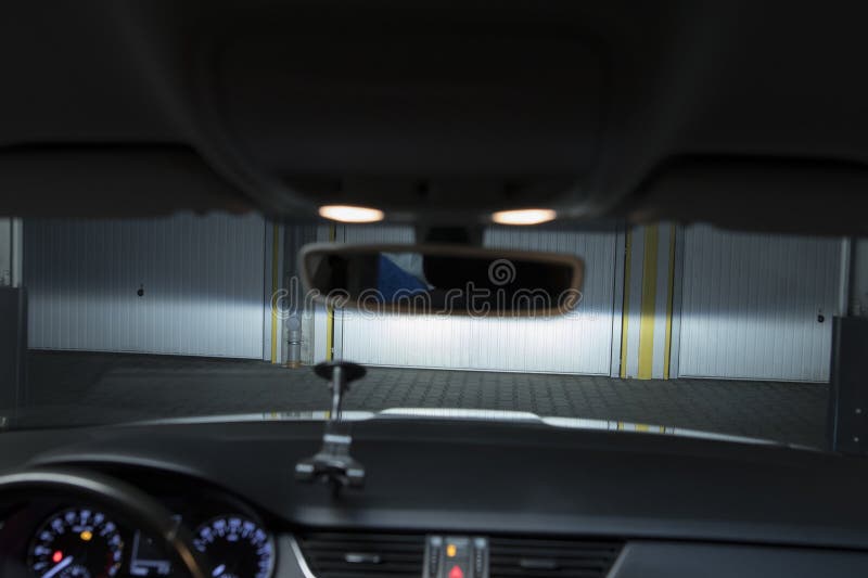 Garage Spaces in the Underground Garage. Car Lights Illuminate the
