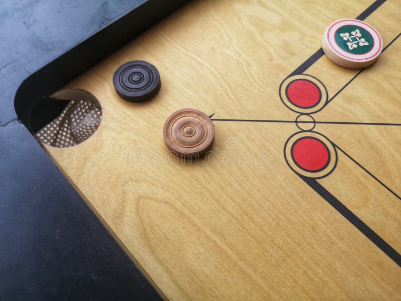 View a Carrom Striker and Carrom Men Balls on the Carrom Board. Play the Game. Selective Focus