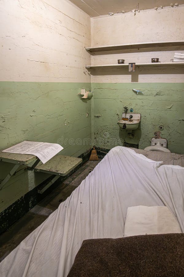 San Francisco, CA, USA - July 12, 2023: Inside historic Alcatraz prison. View in cell with personal hygiene facilities, bed and wall boards to stack stuff. San Francisco, CA, USA - July 12, 2023: Inside historic Alcatraz prison. View in cell with personal hygiene facilities, bed and wall boards to stack stuff