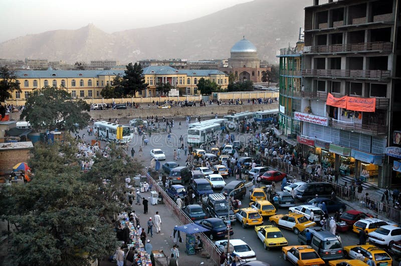 A view of central Kabul, Afghanistan showing the traffic, mosque, crowds of people and distant hills.