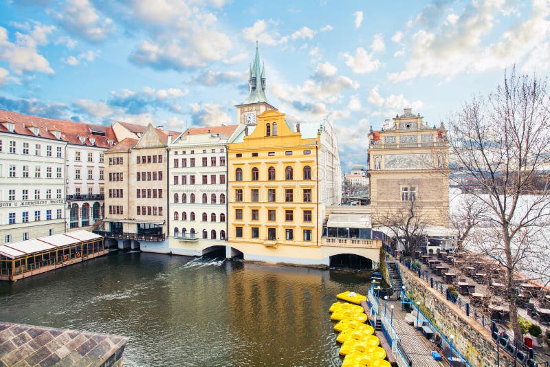 View from Charles Bridge and Old Town Bridge Tower on Vltava river, cloudy sky and yellow boats, Prague royalty free stock photo View from Charles Bridge and Old Town Bridge Tower on Vltava river, cloudy sky and yellow boats, Prague royalty free stock photo
