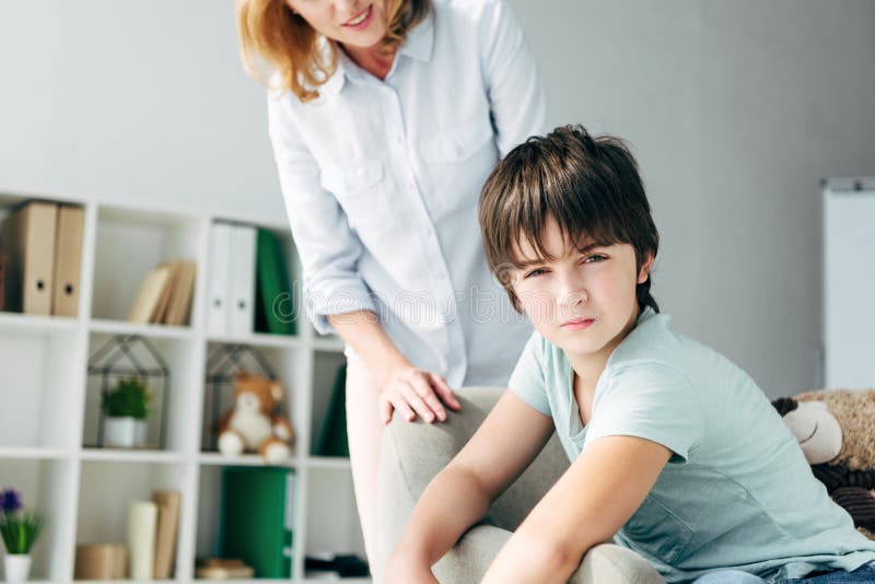 View of Child Psychologist Looking at Kid with Dyslexia Stock Image