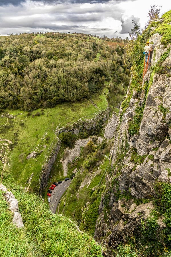 View from cliff edge of Cheddar Gorge and mountain climber in Somerset stock image