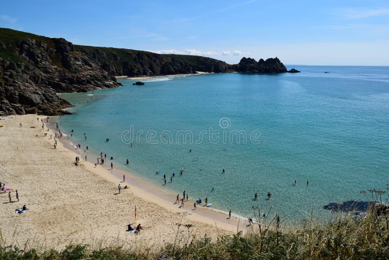 View from the cliffs at Porthcurno, Cornwall, England. View from the cliffs at Porthcurno beach, Cornwall, England on a sunny day stock photo
