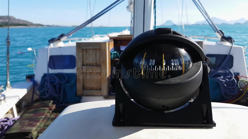 View of compass on yacht dashboard. Moving straight to North