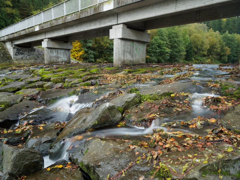 View of the concrete bridge under which the river flows royalty free stock photo