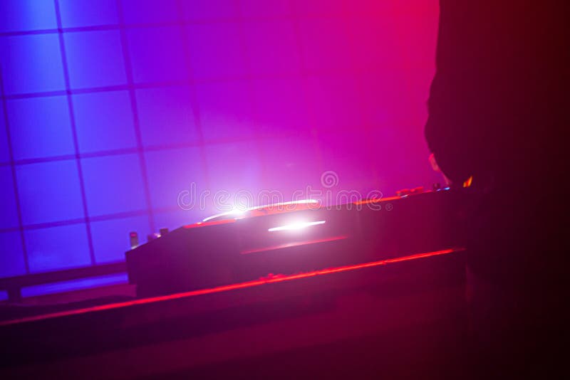 View of Electronic Dj Turntable Mixing Board in Dark Club Stock Photo