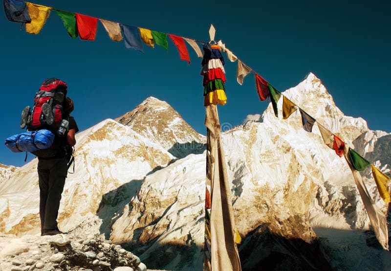 View of Everest with tourist and buddhist prayer flags