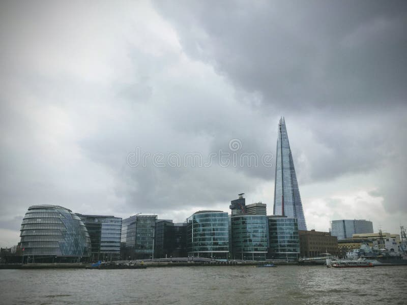 A view of the famous London City Hall from the bank of river Thames against a dramatic cloudy sky stock photography A view of the famous London City Hall from the bank of river Thames against a dramatic cloudy sky stock photography