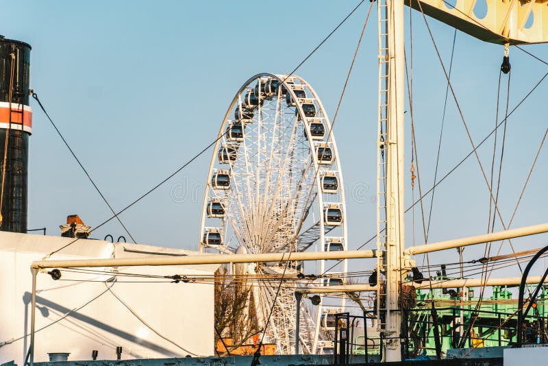 View of the ferris wheel through the ship on the embankment of the Motlawa river in the city of Gdansk, Poland. Ferris wheel in stock image View of the ferris wheel through the ship on the embankment of the Motlawa river in the city of Gdansk, Poland. Ferris wheel in stock image