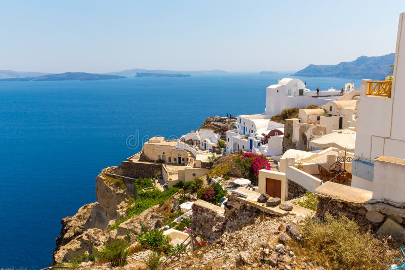 View of Fira town - Santorini island, Crete, Greece. White concrete staircases leading down to beautiful bay