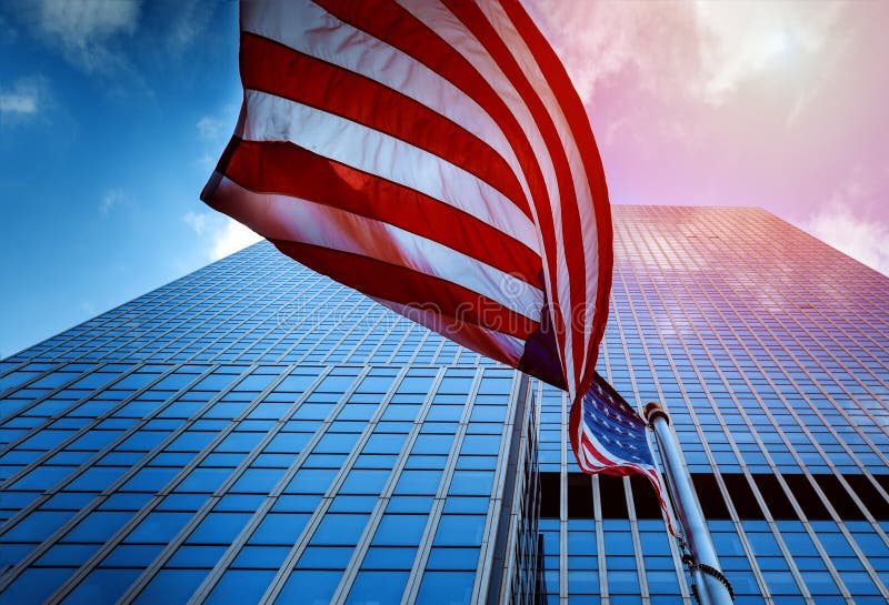 View of the Flag of the United States of America Flying in the a High Rise Glass Tower