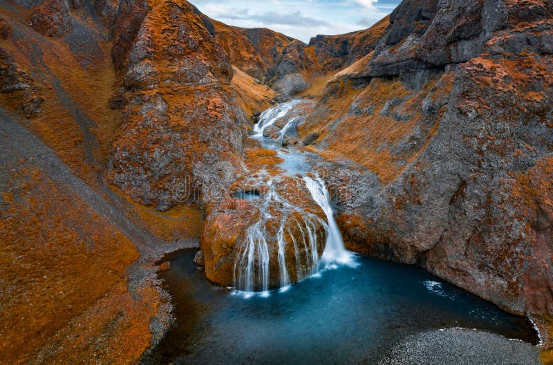 View from flying drone of Stjornarfoss waterfall at midnight sun. Splendi autumn scene of Iceland, Europe. Beauty of nature concep