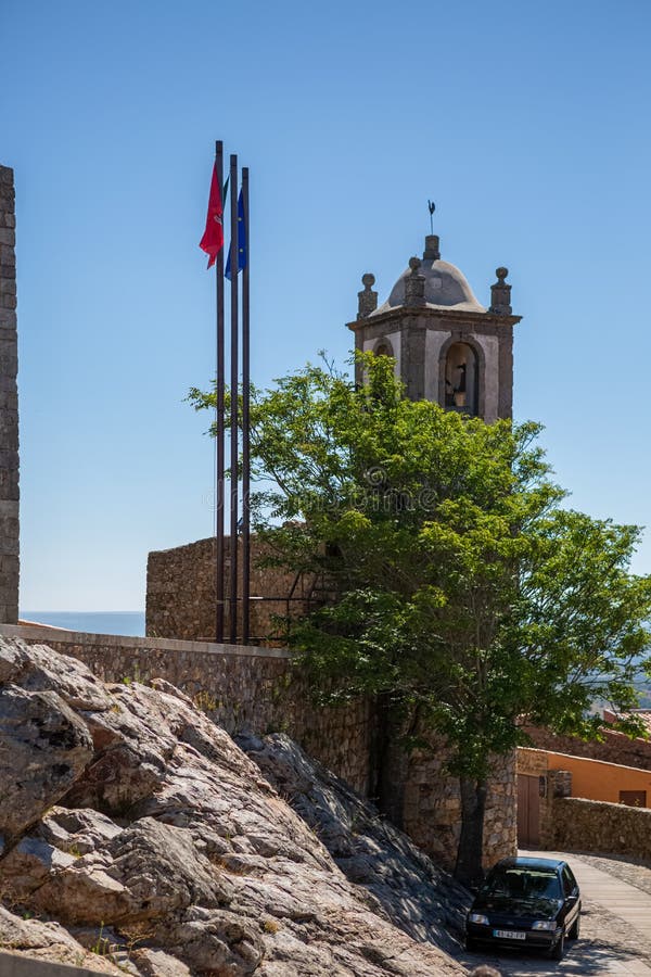 View at the fortress ruins at the medieval village of Figueira de Castelo Rodrigo, tower bell with flags stock photos