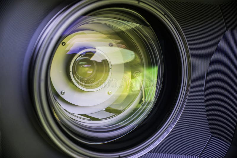 View of the Glass Elements in a Camera Lens. Objective Under Yellow Light. Tiltshift Use. Stock
