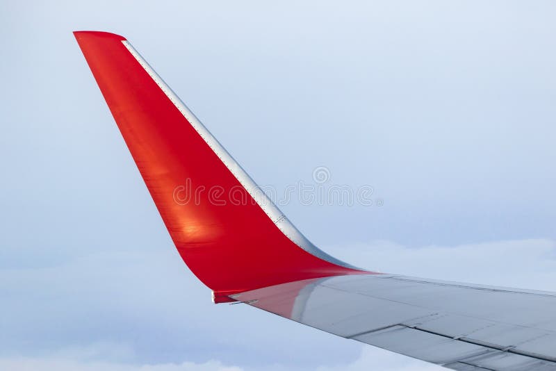 View of the gray sky from the height of flight above the clouds from the window of the plane in the bright sun. part of an airplane wing in the frame. Airplane height stock images, royalty-free photos and pictures