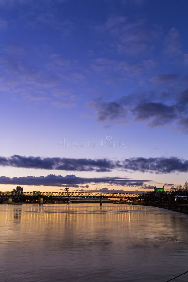 View from harbour at sunset, Bratislava castle, business buildings and river Danube, Slovakia