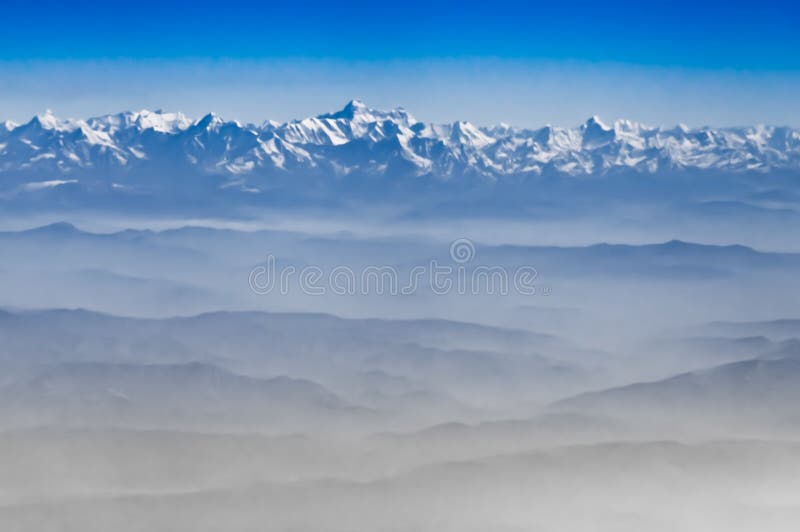 View from the height of the Himalayan mountains from an airplane in the early morning, a landscape in blue colors. blue sky of the Himalayas and foothills. Airplane height stock images, royalty-free photos and pictures