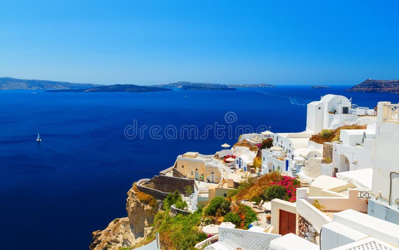 View from the height of the sea and the Caldera from Fira. A traditional village with white buildings on a steep cliff