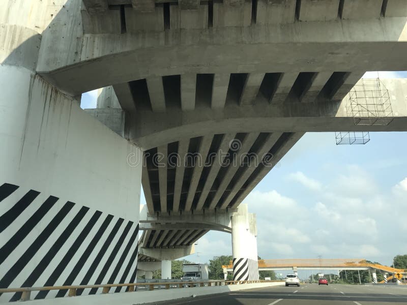 View of the highway under a black and white bridge royalty free stock image View of the highway under a black and white bridge royalty free stock image