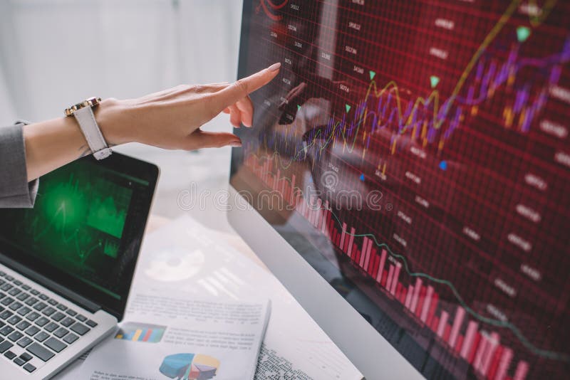 View of information security analyst pointing with finger on charts on computer monitor royalty free stock photography