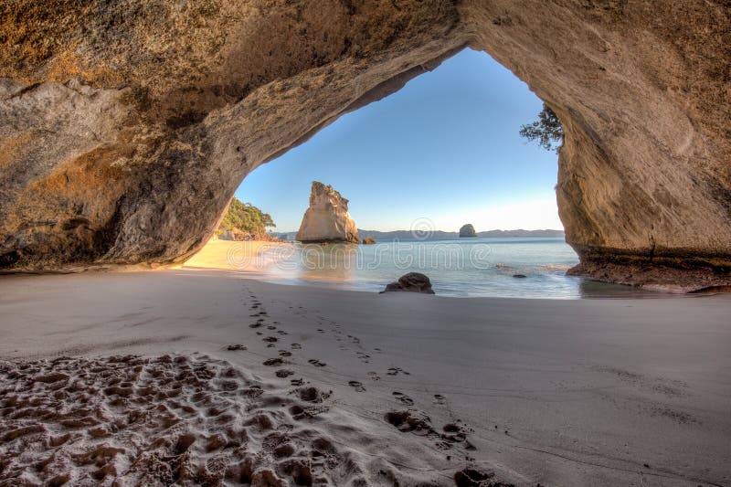 Inside the tunnel or cave at Cathedral Cove New Zealand, looking out to a sunny day. Inside the tunnel or cave at Cathedral Cove New Zealand, looking out to a sunny day