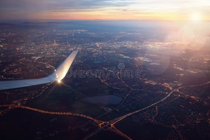 View from landing airplane window of city at sunset royalty free stock photography View from landing airplane window of city at sunset royalty free stock photography