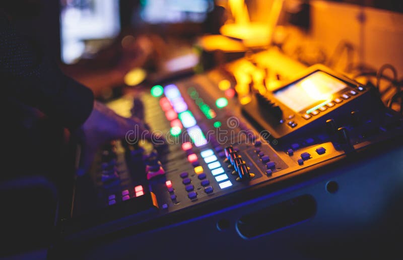View Of Lighting Technician Operator Working On Mixing Console view-of-lighting-technician-operator-working-on-mixing-console
