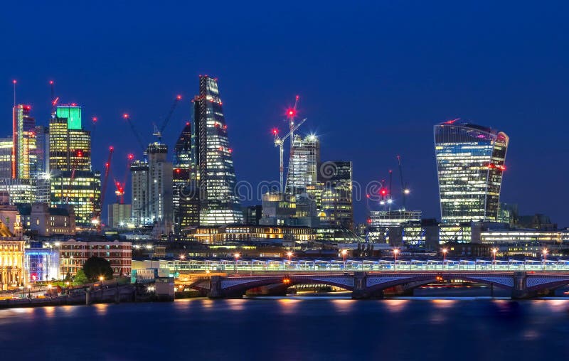 The view of London`s city hall and modern skyscrapers at night stock photography The view of London`s city hall and modern skyscrapers at night stock photography