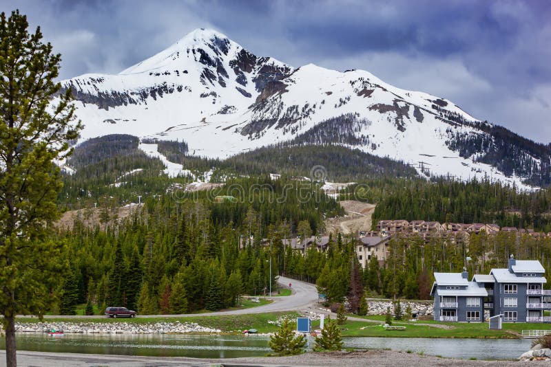 View of Lone Mountain with buildings and pine trees on the foot of the mountain, Big Sky, Montana, USA