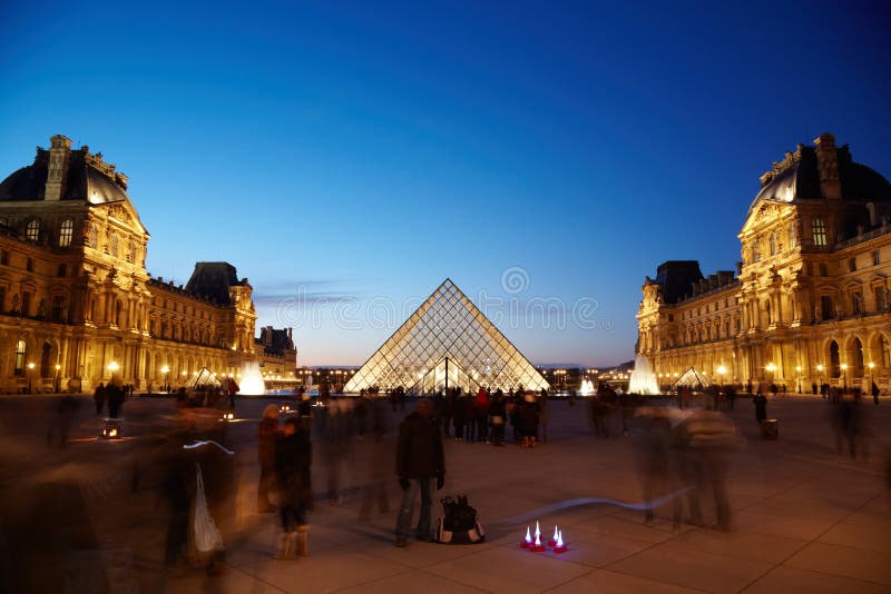 PARIS - JANUARY 1: View on Louvre pyramid from inner courtyard side, January 1, 2010, Paris, France. The pyramid is surrounded by fountains and three pyramids less size.